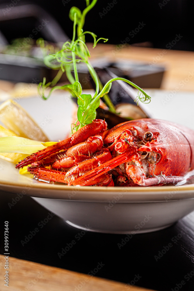 French cuisine concept. Crab fish soup with seafood, with salmon, scallop, squid, mussels. Serving dishes in a restaurant in a white plate. background image. copy space. French cuisine concept. Crab fish soup with seafood, with salmon, scallop, squid, mussels. Serving dishes in a restaurant in a white plate. background image. copy space.