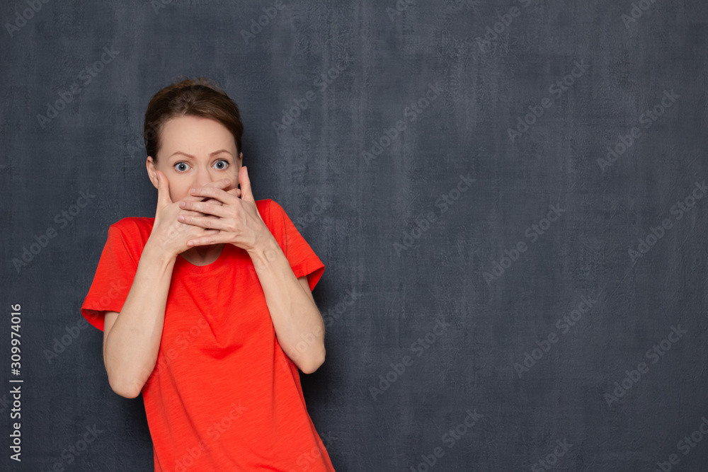 Portrait of shocked scared girl covering mouth with hands Portrait of shocked scared girl covering mouth with hands