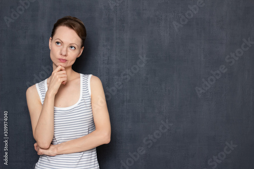 Portrait of thoughtful focused girl imagining something in mind
