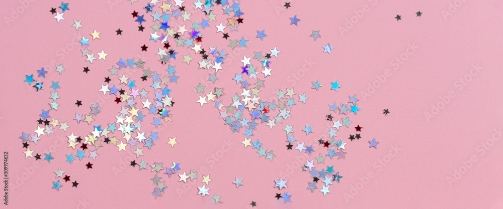 Shiny glitter stars on light pink background. Abstract Christmas, holiday background frame