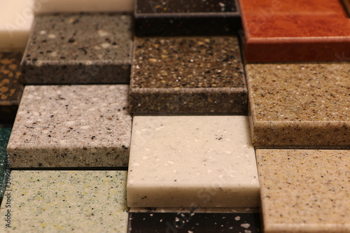 Top view of color samples stone  on oak wood table, Acrylic Solid Surface