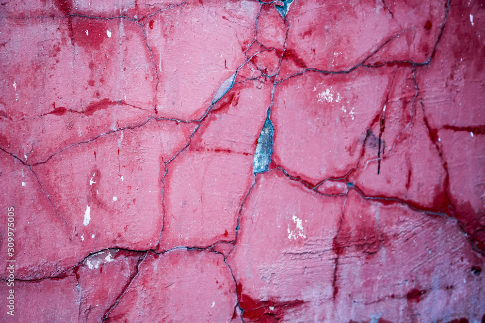 Naklejka premium Cracks on a pink wall closeup