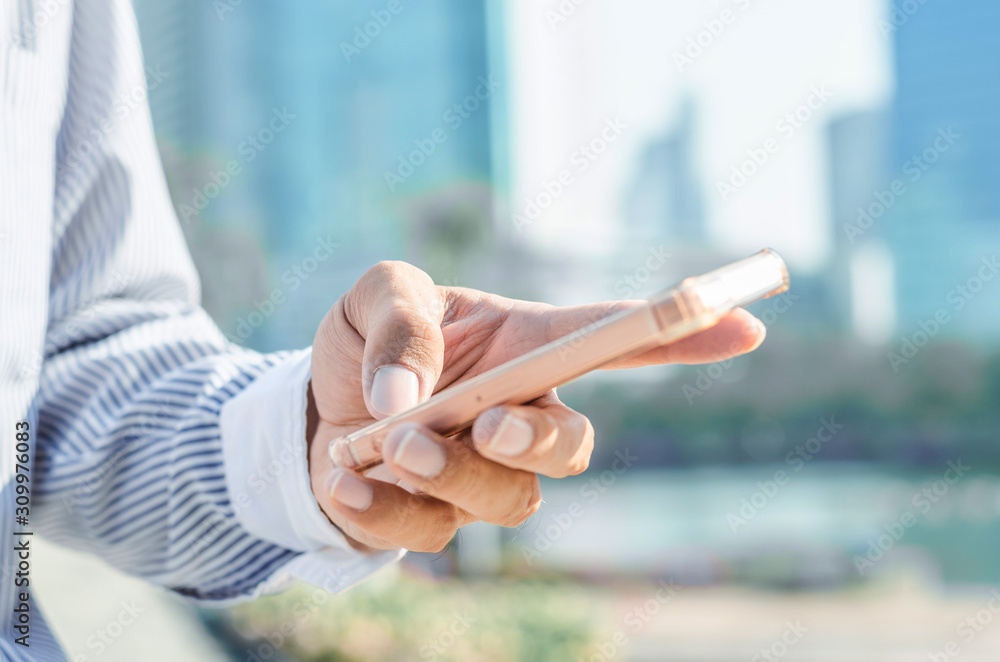 5G technology world wide web connecting.close up business man using hand typing smartphones and touch screen working search with app devices outdoor in city with sunrise and building background. 5G technology world wide web connecting.close up business man using hand typing smartphones and touch screen working search with app devices outdoor in city with sunrise and building background.