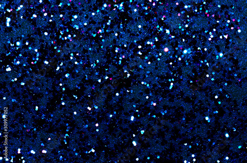 Schilderij op canvas Texture of multicolor glitter spangles on a dark blue background with space for text