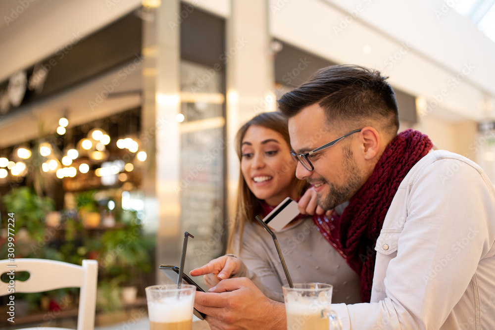 A couple at a mall checking an app store. A couple at a mall checking an app store.