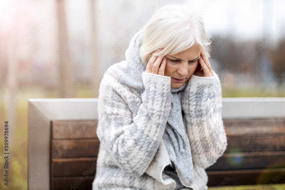 Senior woman suffering from a headache Senior woman suffering from a headache