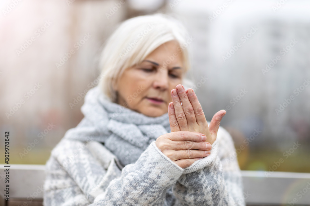 Senior woman with arthritis rubbing hands Senior woman with arthritis rubbing hands