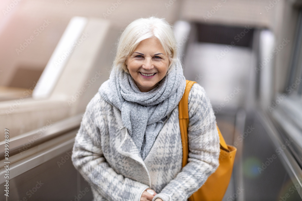 Happy Senior Woman On Escalator Happy Senior Woman On Escalator