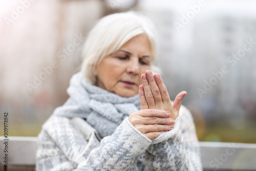 Cuadro en lienzo Senior woman with arthritis rubbing hands
