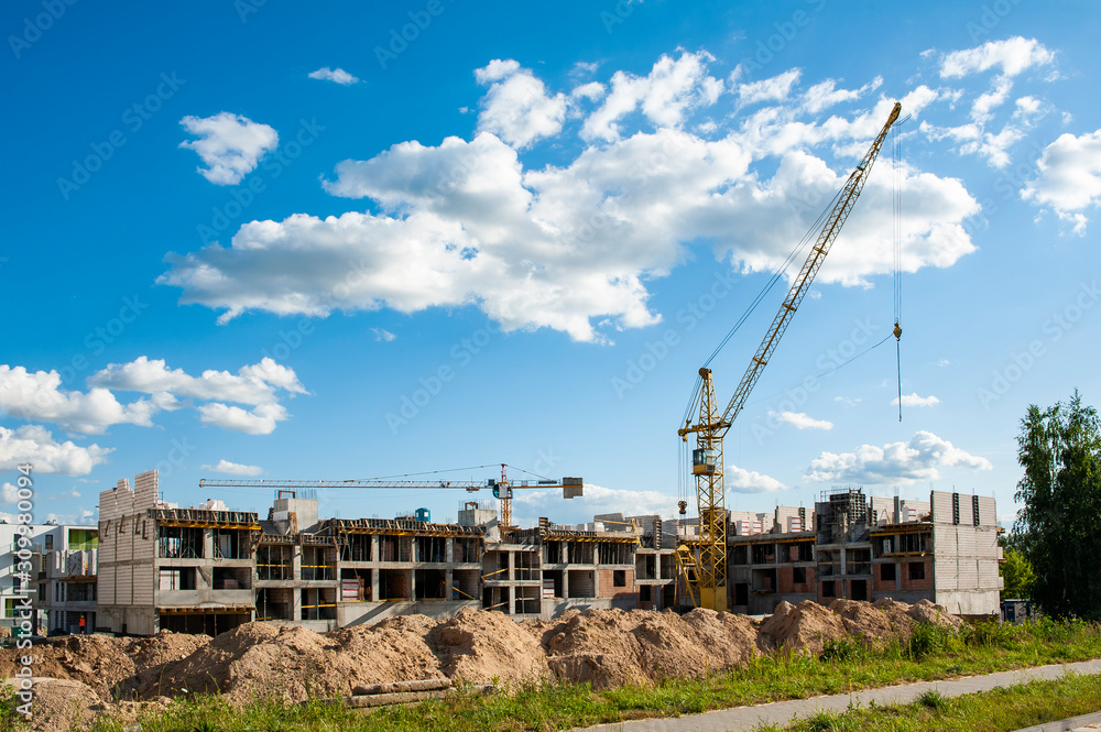 Fototapeta premium Residential building under construction on a sunny summer day