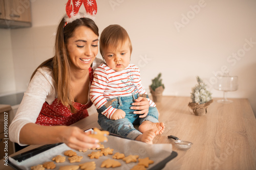 A mother and a child checking out the cookies they baked for Christmas.