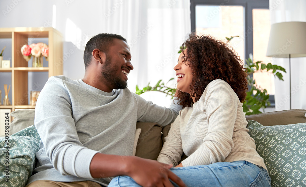 relationships and people concept - happy african american couple at home