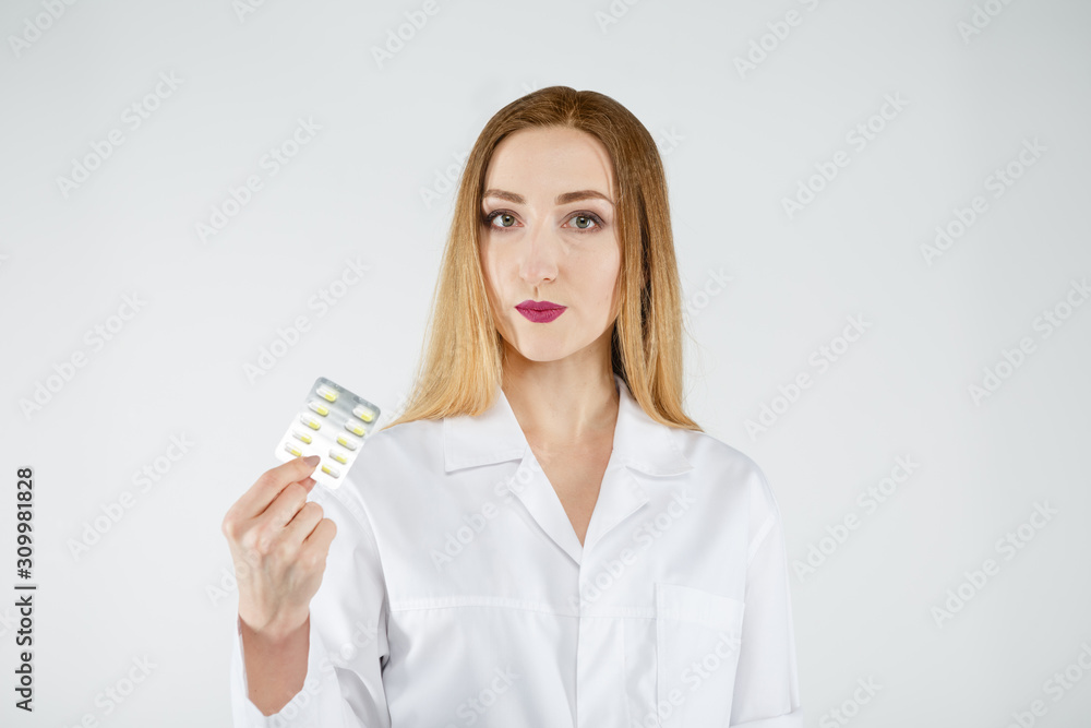 Young doctor woman in medical gown with tablets in her hand. Young doctor woman in medical gown with tablets in her hand.