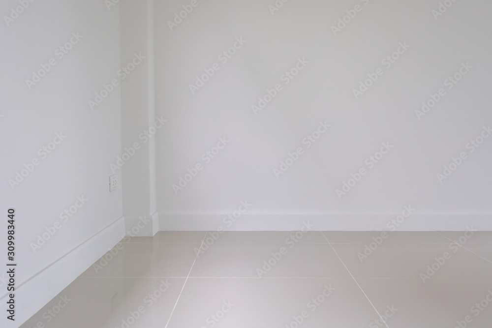empty room interior, white mortar wall and clean tile floor in a new house empty room interior, white mortar wall and clean tile floor in a new house