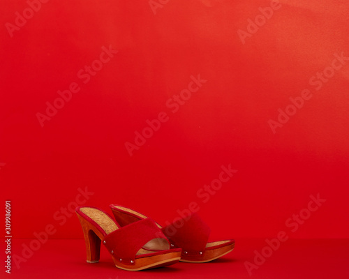 Red women shoes on a red background