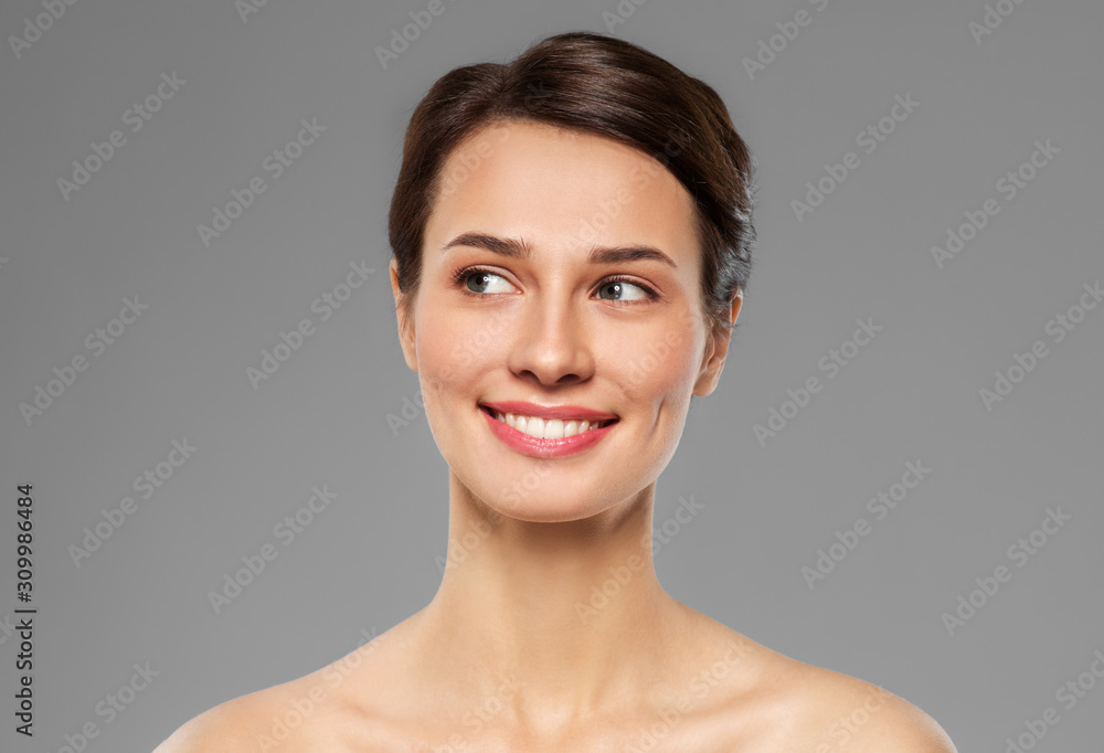 beauty, bodycare and people concept - beautiful smiling young woman with bare shoulder over grey background beauty, bodycare and people concept - beautiful smiling young woman with bare shoulder over grey background