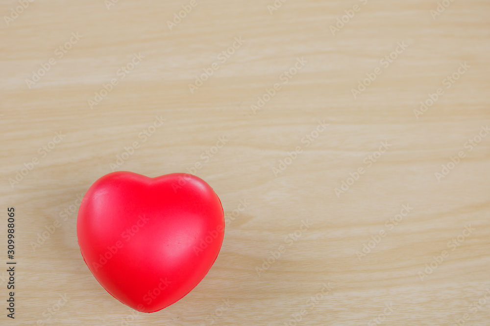 Red heart on hand on wooden background. Red heart on hand on wooden background.
