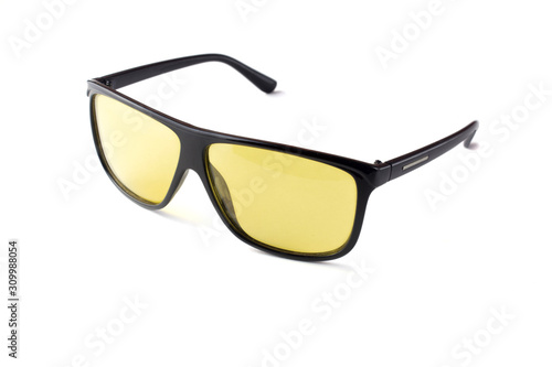 black plastic sunglasses with yellow lenses on a white isolated background.