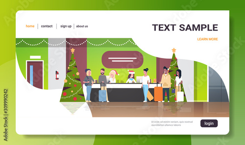 female receptionists in santa hats meeting mix race tourists with luggage at reception counter registration christmas holiday concept modern hotel lobby interior full length horizontal copy space