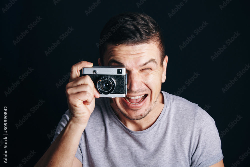 guy with an old camera, cheerful smile at you guy with an old camera, cheerful smile at you