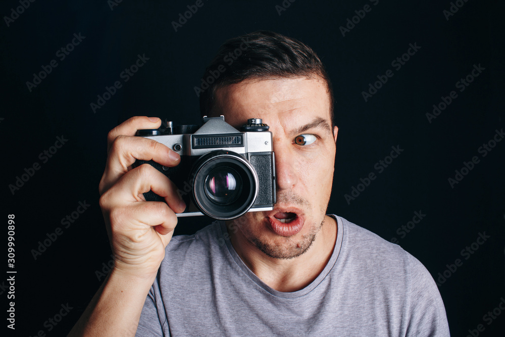 guy with an old camera, cheerful smile at you guy with an old camera, cheerful smile at you