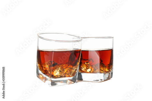 Glasses of whiskey with ice cubes isolated on white background