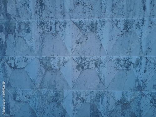 close-up of a decorative wall, with bokeh effect and characteristic rough porous texture, abstract dark and light stains