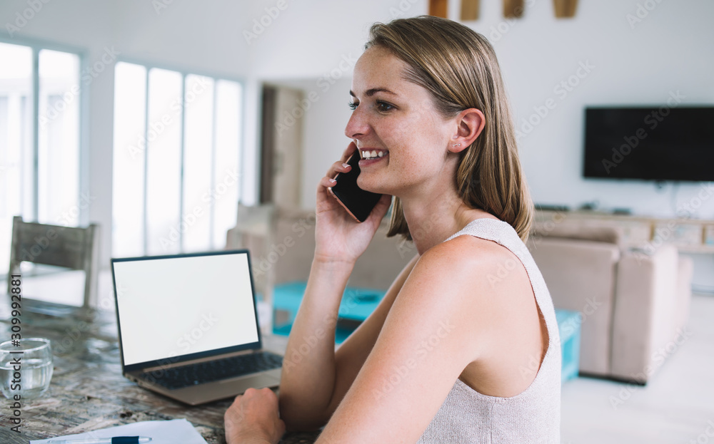 Confident woman working at home and speaking on phone