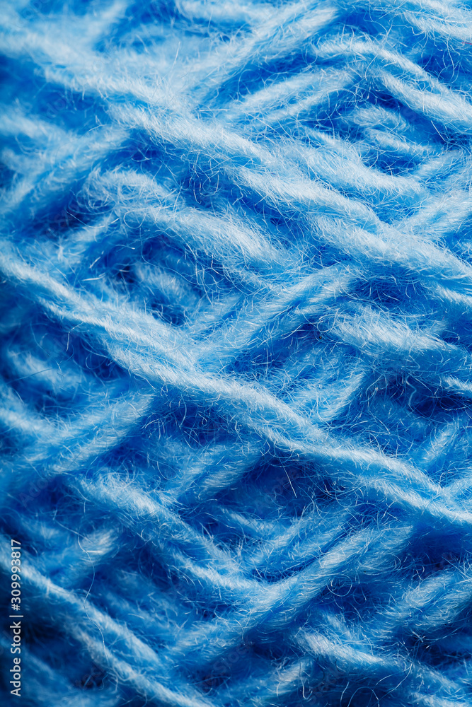 Wool yarn close-up colorful blue threads for needlework.