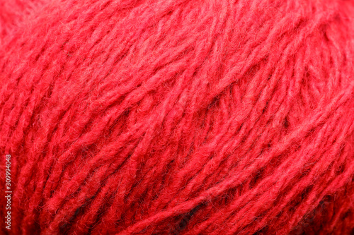 Wool yarn close-up colorful red thread for needlework in macro.