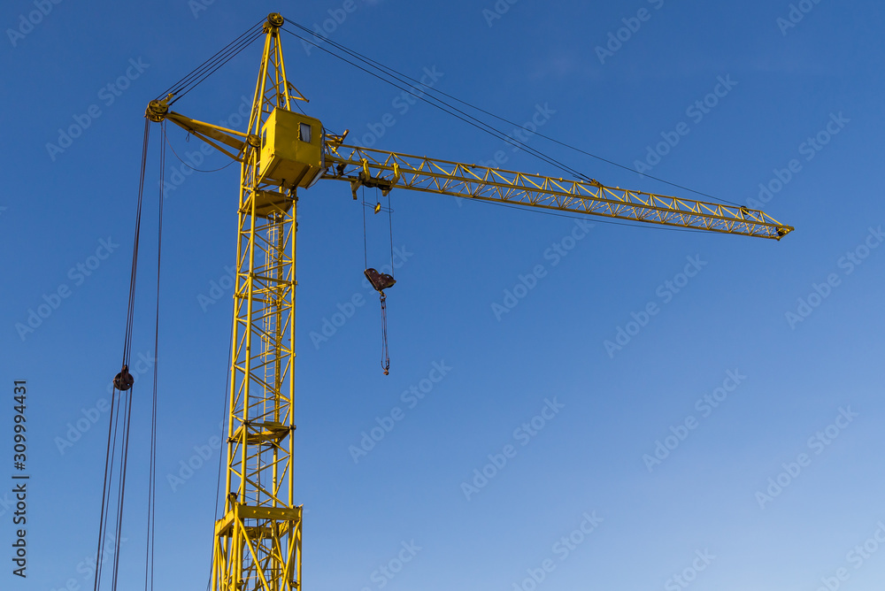lifting yellow crane on blue sky background copy space lifting yellow crane on blue sky background copy space