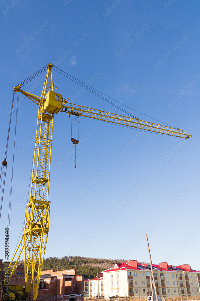 yellow crane on blue sky background