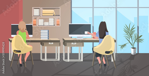 businesswomen couple sitting at workplace desk business women using computer drinking coffee coworking center modern open space office interior rear view full length horizontal vector illustration