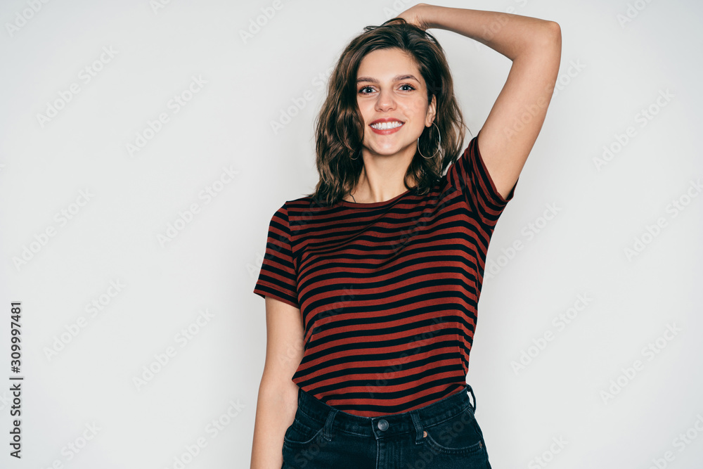 Cheerful adult beautiful female in casual outfit putting hand on head in studio Cheerful adult beautiful female in casual outfit putting hand on head in studio