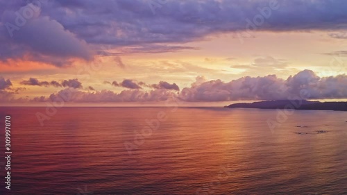 Wallpaper Mural 4K Wide Aerial Drone Shot of Beautiful Sunset over the Beach of Tambor, Costa Rica.
Saturated colorful Sunset with Fluffy Clouds and Amazing Reflection on the Ocean. Torontodigital.ca