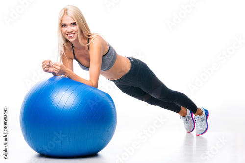Fitness, sport, training and healthy lifestyle concept - smiling blond woman exercising with fitball, at home or fitness studio, isolated over white background