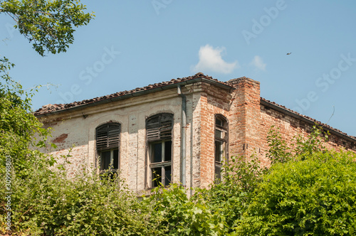 Old weathered rural countryside house clay brick wall closeup © varbenov