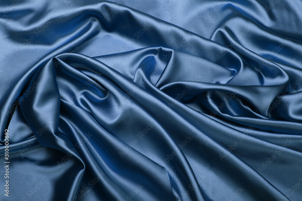 Fototapeta premium Blue color silk fabric. Abstract background.