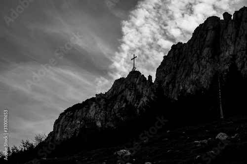 Beautiful alpine black and white view with the summit cross of the famous Kampenwand, Aschau im Chiemgau, Bavaria, Germany