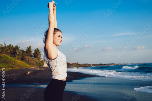 Fotografija Healthy happy woman stretching arms at seaside