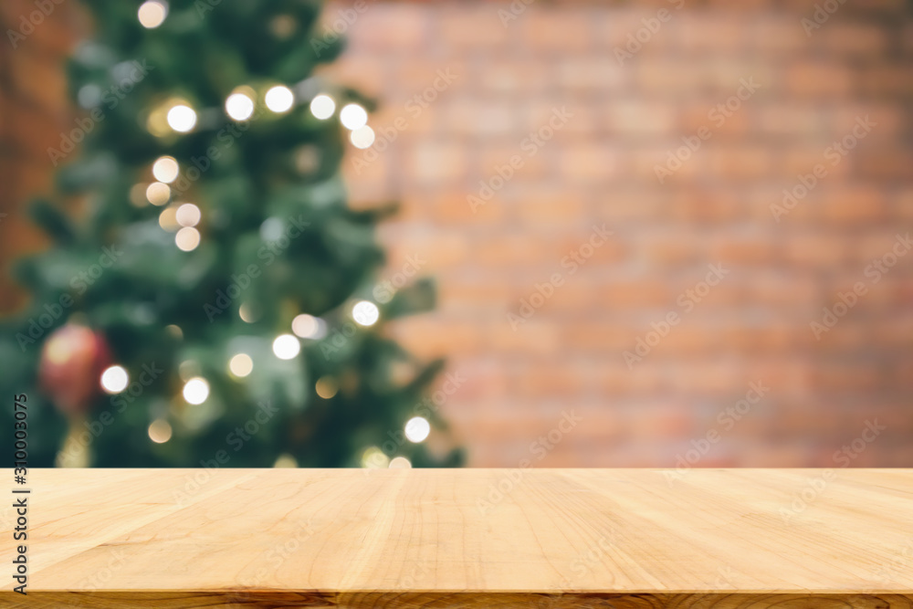 Empty wood table top with abstract blur decorated Christmas tree with baubles New Year holidays background for mockup product display Empty wood table top with abstract blur decorated Christmas tree with baubles New Year holidays background for mockup product display