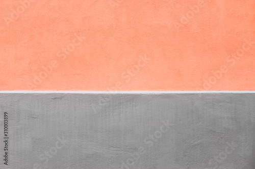 Peachy and grey wall texture background. Beautiful colorful stone wall covered with stucco and paint. Close up, copy space