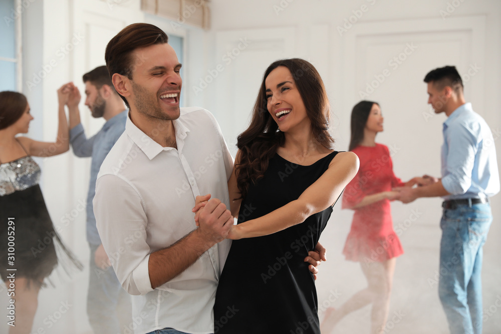 Fototapeta premium Lovely young couple dancing together at party