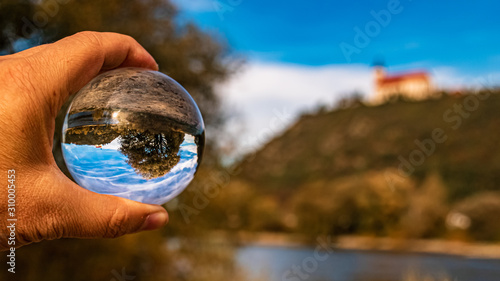 Crystal ball held in my hand landscape shot near Bogenberg, Danube, Bavaria, Germany