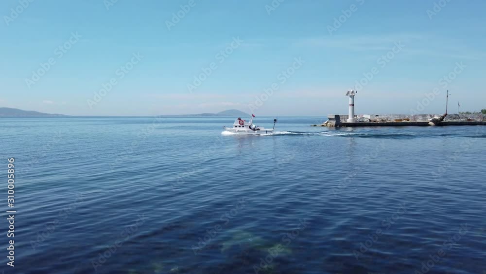 Marmara Island, Turkey - April 2019: A fishing boat in the harbour of Marmara island village in sea of Marmara. It is 2 hours away from istanbul with ferryboat Marmara Island, Turkey - April 2019: A fishing boat in the harbour of Marmara island village in sea of Marmara. It is 2 hours away from istanbul with ferryboat