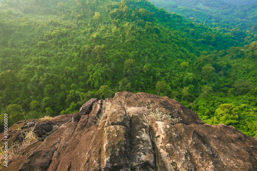 Looking down the cliff have forest background