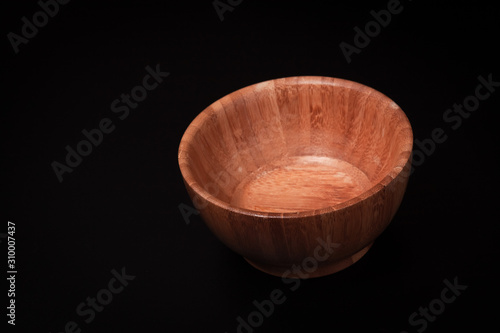 brown bamboo bowl, on a black background.