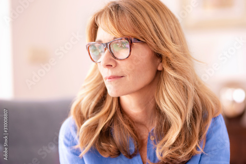 Thinking mature woman close-up portrait