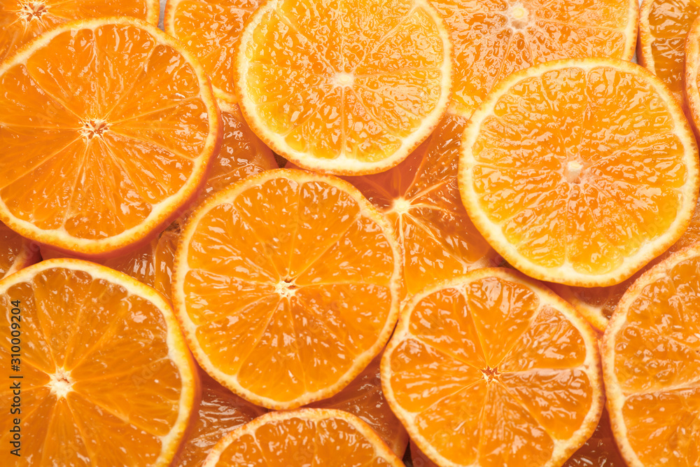 Slices of fresh ripe tangerines as background, top view. Citrus fruit Slices of fresh ripe tangerines as background, top view. Citrus fruit