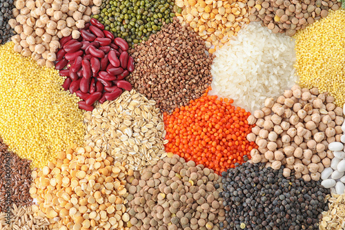 Different types of legumes and cereals as background, top view. Organic grains photo